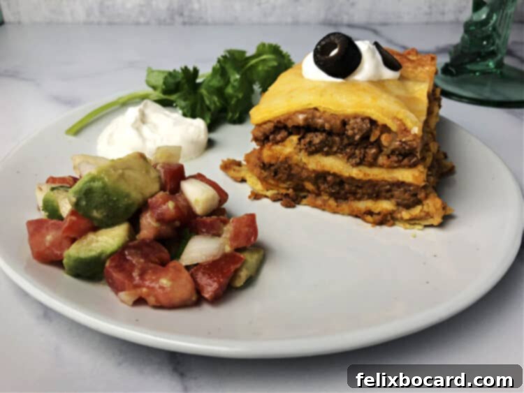 Burrito Bake 12 burrito pie on a plate with salsa and sour cream