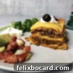 Burrito Bake 14 burrito pie on a small plate with salsa and sour cream