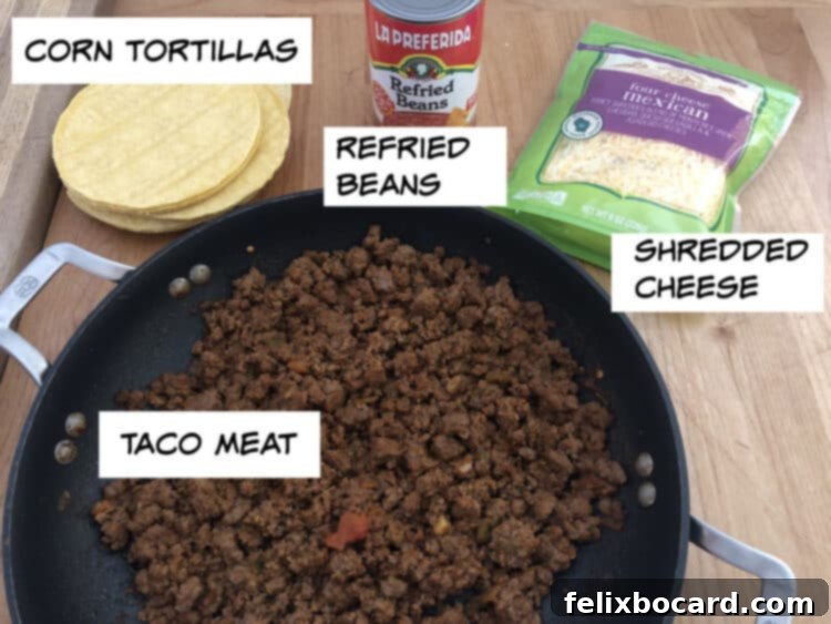 Burrito Bake 3 ingredient image: taco meat, tortillas, refried beans, shredded cheese
