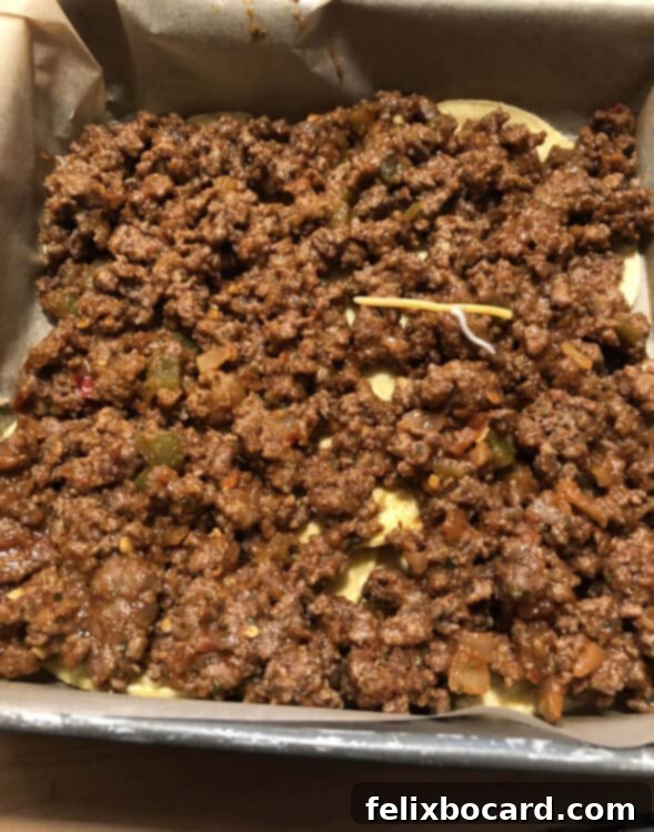 Burrito Bake 8 meat filling layer on top of tortillas