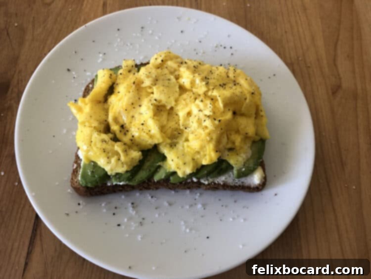 13 Creative Avocado Toast Recipes 11 Avocado toast topped with soft scrambled eggs, offering a protein-rich and satisfying breakfast option.