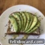 13 Creative Avocado Toast Recipes 17 Avocado slices in a fan shape on toast, ready for toppings.