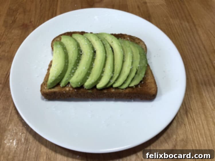 13 Creative Avocado Toast Recipes 3 Slices of perfectly ripe avocado arranged on golden-brown toast, seasoned with a sprinkle of sea salt.