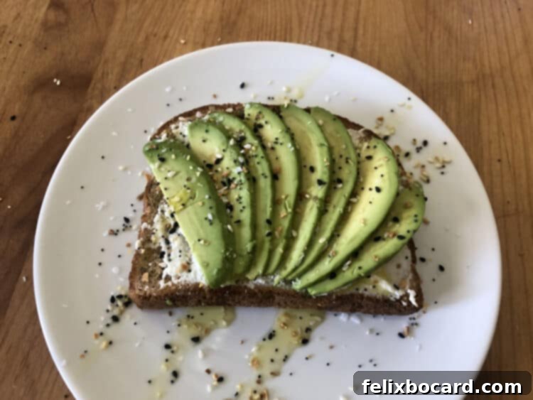 13 Creative Avocado Toast Recipes 5 Avocado toast featuring a creamy layer of ricotta cheese, sliced avocado, a drizzle of olive oil, and Everything But the Bagel seasoning.