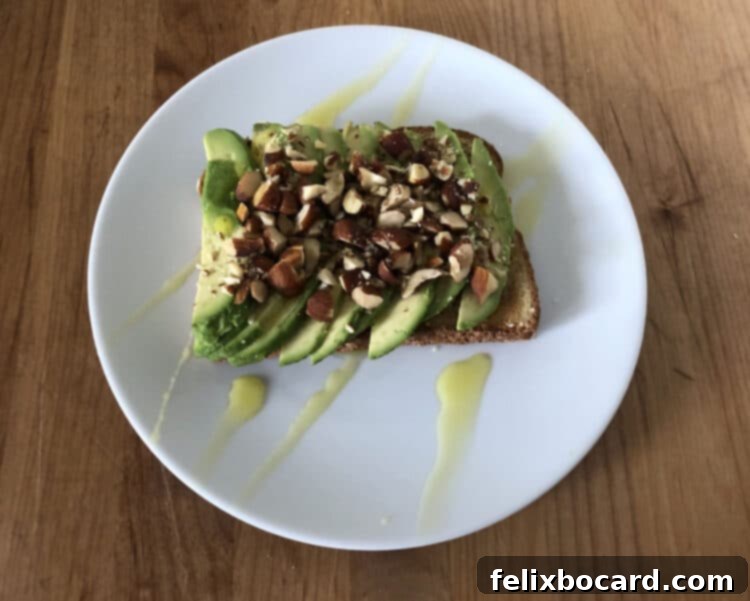 13 Creative Avocado Toast Recipes 7 Avocado toast generously topped with crunchy chopped almonds and a lustrous drizzle of olive oil, a true healthy fat powerhouse.