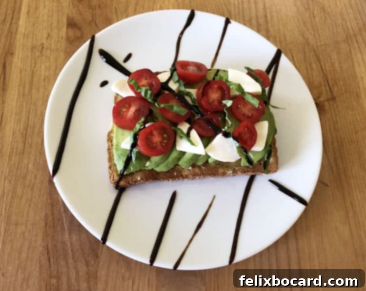 13 Creative Avocado Toast Recipes 10 Avocado toast showcasing a beautiful arrangement of fresh mozzarella, ripe tomatoes, and basil, finished with balsamic glaze, reminiscent of a Caprese salad.