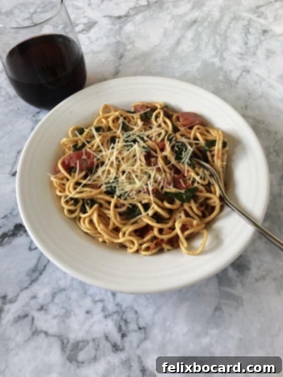 Easy weeknight pasta in a bowl with a glass of wine nearby, suggesting a relaxing and enjoyable meal.