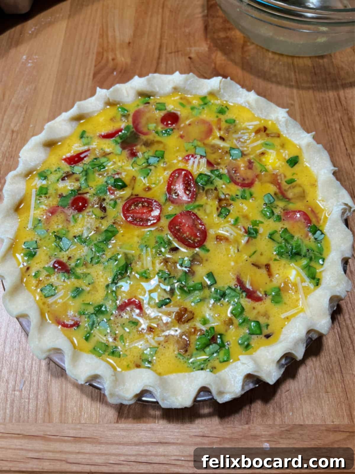 All Caprese quiche ingredients added to the crust, ready to bake.