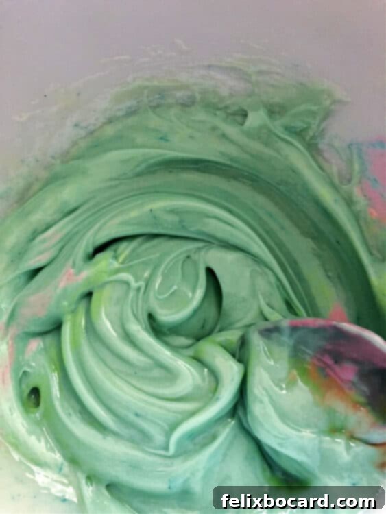 stirring light blue green colored ingredients in a bowl