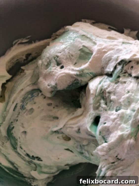 whipped topping being folded in to the ingredients in a bowl