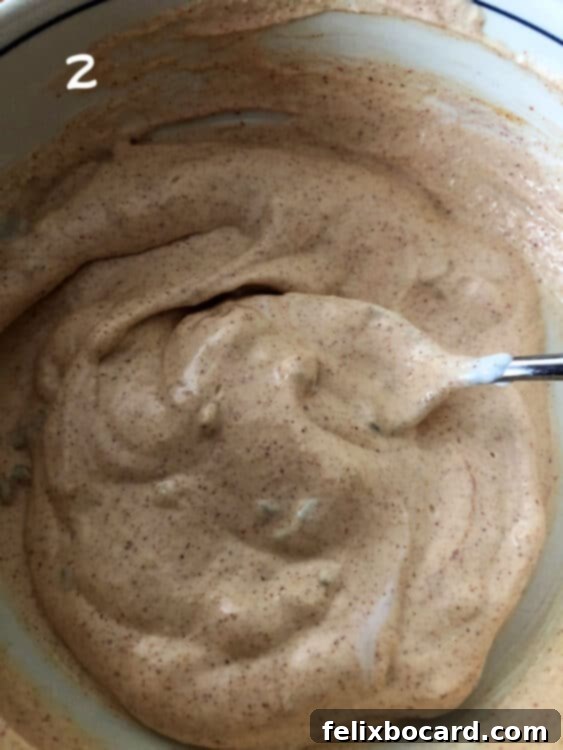 Copycat Taco Bell Creamy Jalapeno Quesadilla Sauce 4 Close-up of the creamy sauce being mixed together in a bowl, showcasing its smooth texture.
