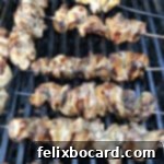 Chinese chicken on a stick (skewers) cooking on a BBQ grill