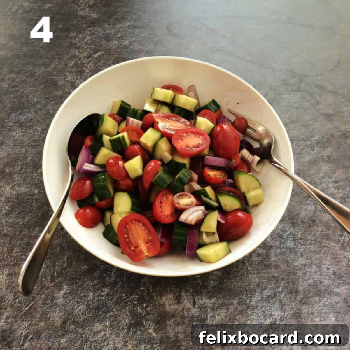 A bowl of fresh vegetables (cucumbers, tomatoes, red onions) lightly coated with balsamic dressing, indicating the first mix.