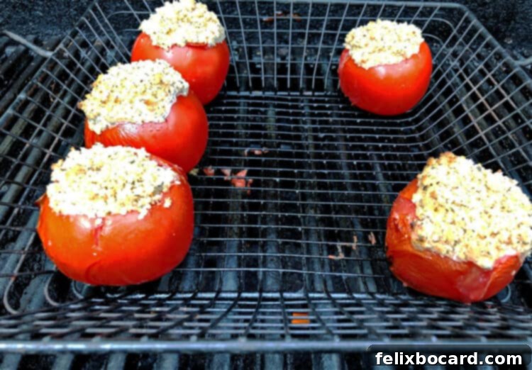 Fire-Roasted Stuffed Tomatoes 3 stuffed tomatoes in a grill basket on the grill