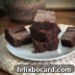 stack of brownies on a white plate with a plant behind