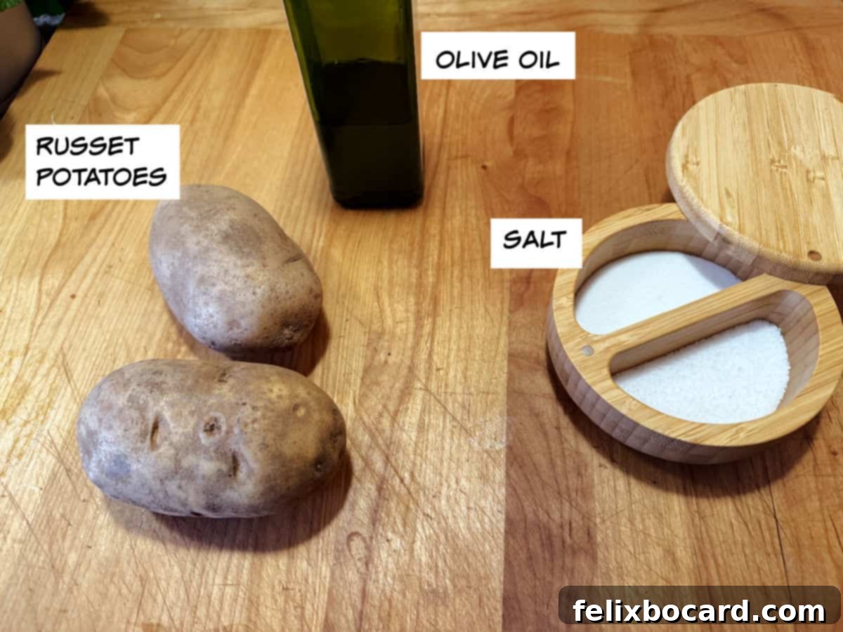 Ingredients for grilled baked potatoes, including russet potatoes, olive oil, and salt