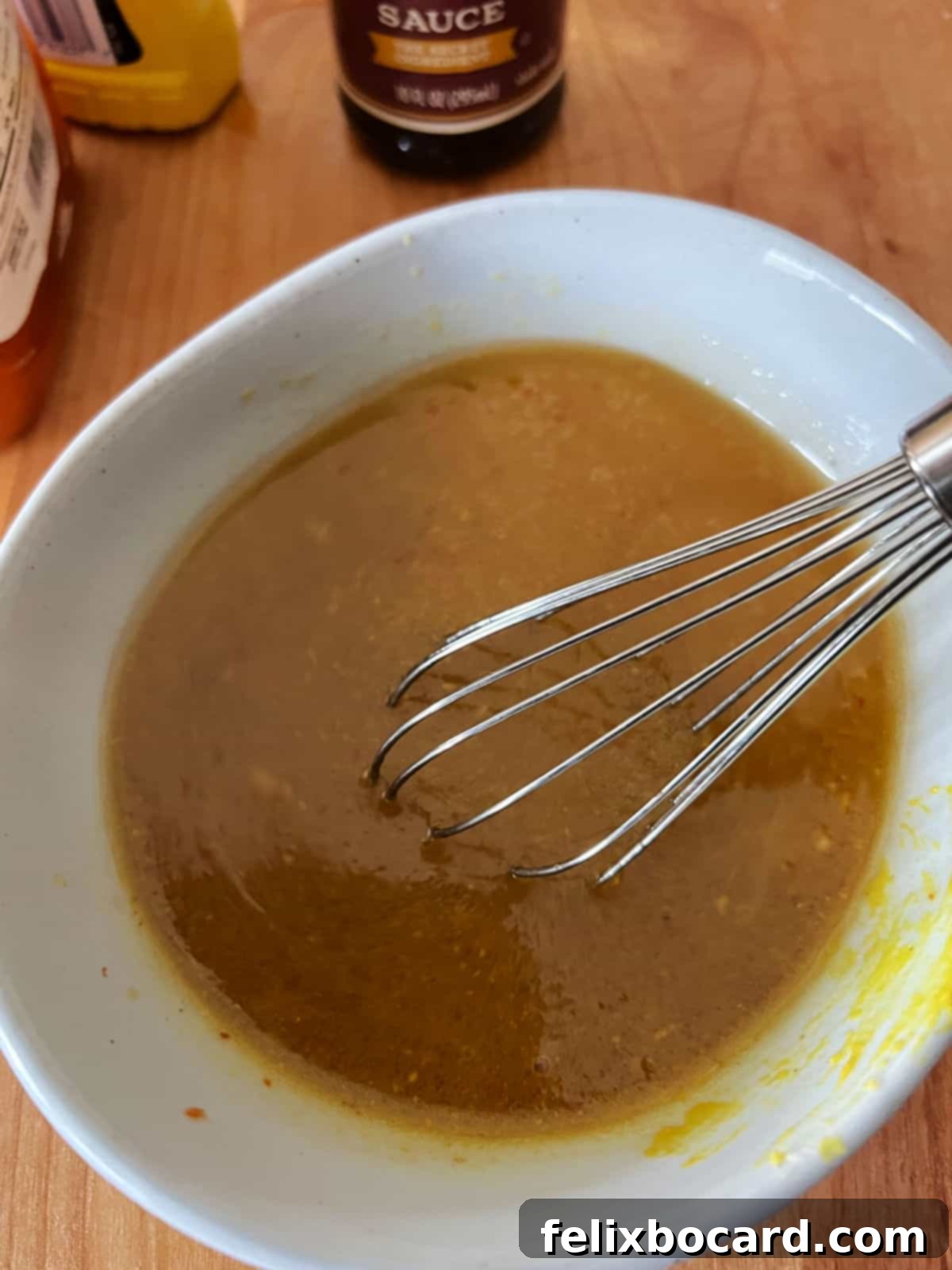 Homemade beef kabob marinade mixed thoroughly in a small bowl with a whisk, ready for the meat.