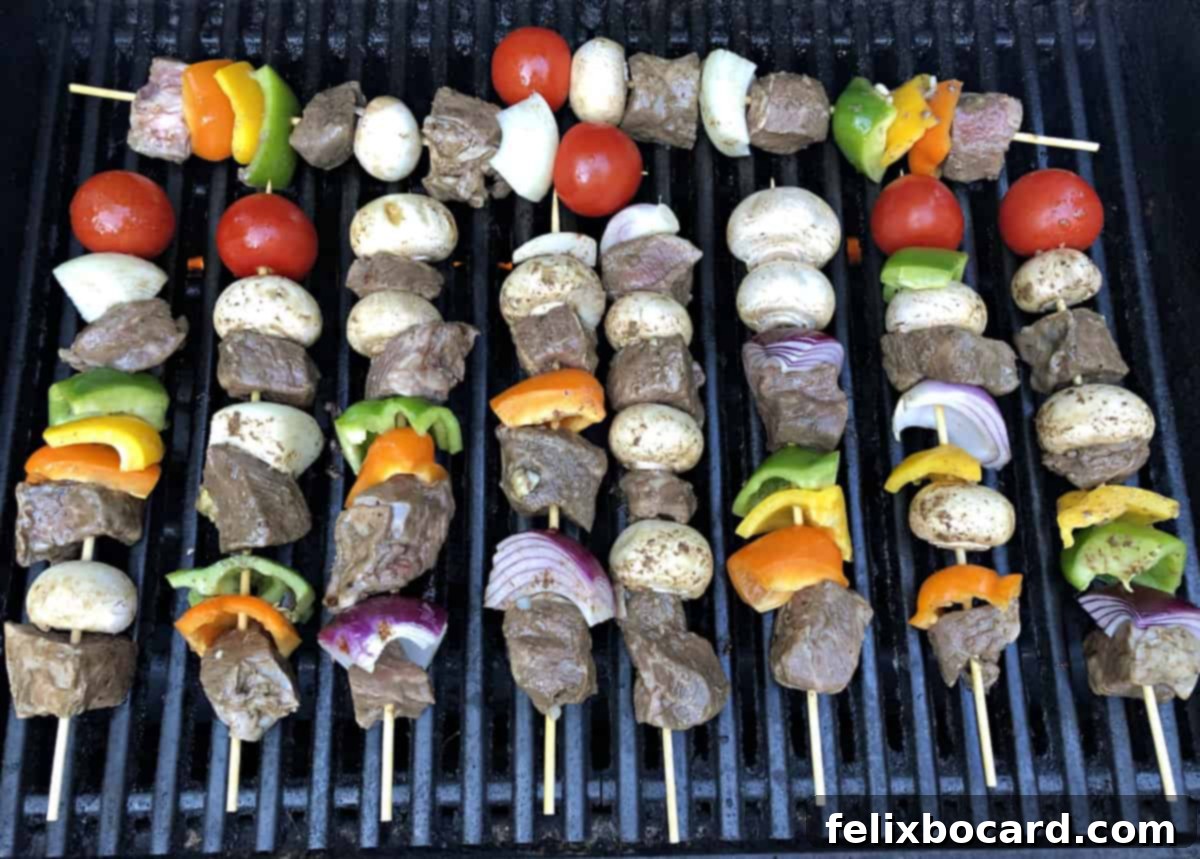 Juicy beef steak and colorful vegetable kabobs cooking to perfection on a hot outdoor grill.