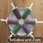 Smoothie popsicles arranged in a circle on a white plate