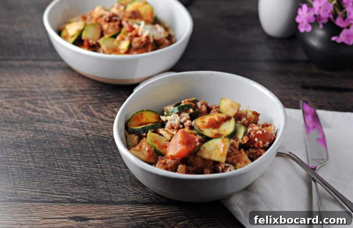 Two small bowls of savory ground beef and zucchini casserole, perfectly portioned and ready to be enjoyed.