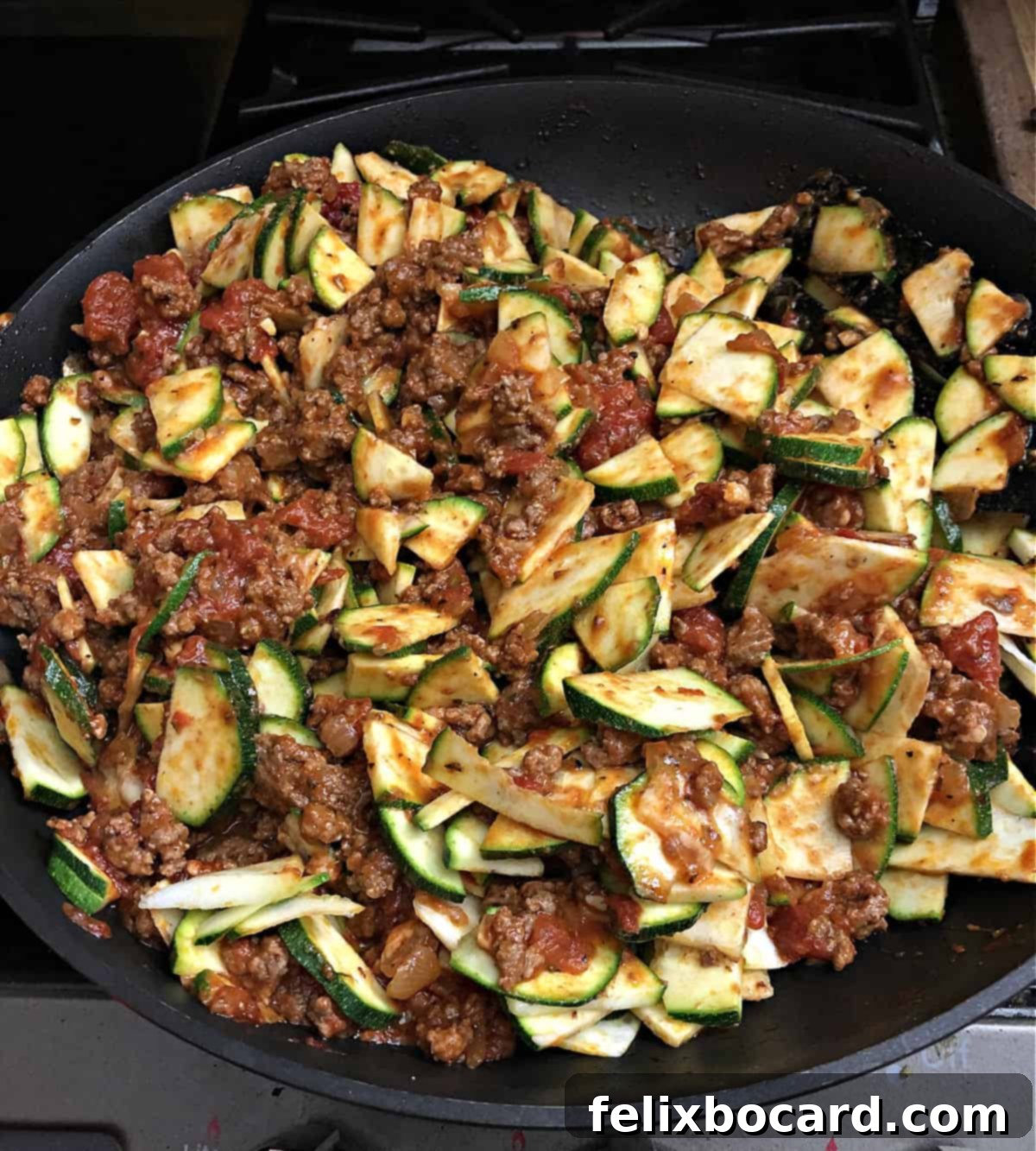 The ground beef and zucchini casserole ingredients fully stirred and ready for baking in a casserole dish.