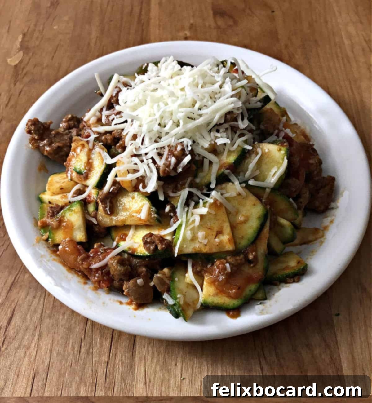 The finished zucchini casserole, beautifully baked with golden-brown cheese on top, ready to be served.