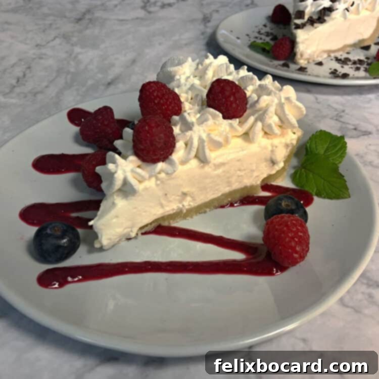 keto cheesecake garnished with berries and fruit sauce