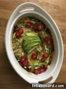 Baked Keto Taco Casserole after baking, garnished with fresh toppings like tomatoes and green onions, showcasing a delicious low-carb meal.