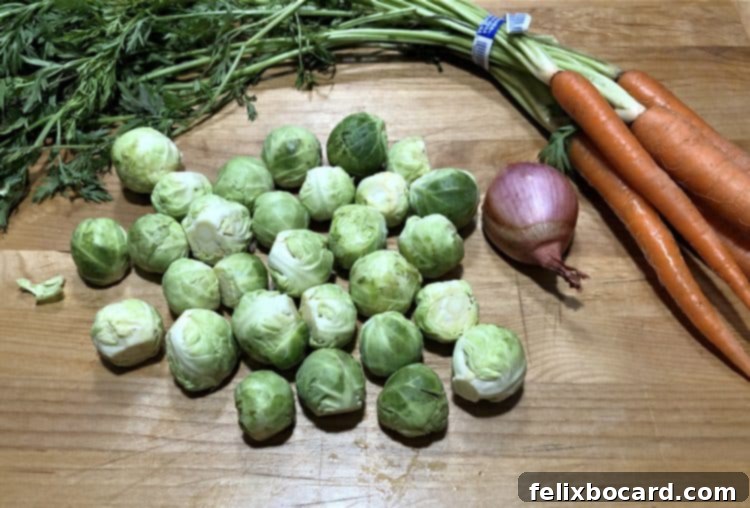 Crispy Brussels and Sweet Carrots 3 Fresh, uncooked Brussels sprouts and carrots laid out, ready for preparation.