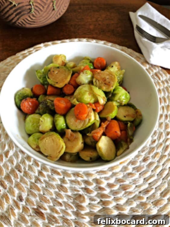 Crispy Brussels and Sweet Carrots 4 A bowl of cooked Brussels sprouts and carrots, garnished and ready to serve.