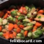 Crispy Brussels and Sweet Carrots 6 Brussels sprouts and carrots cooking in a pan on the stove top.