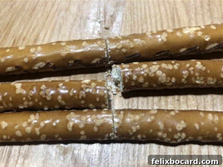 Illustrative image showing pretzel rods being cut to the appropriate length for turkey tail feathers.