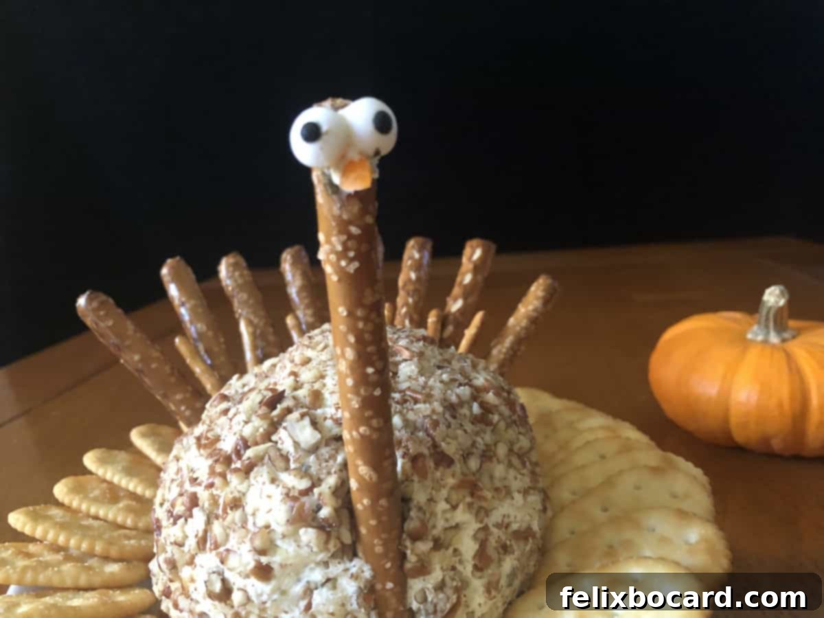 Close-up of the completed turkey cheese ball with its playful googly eyes, ready to be served.
