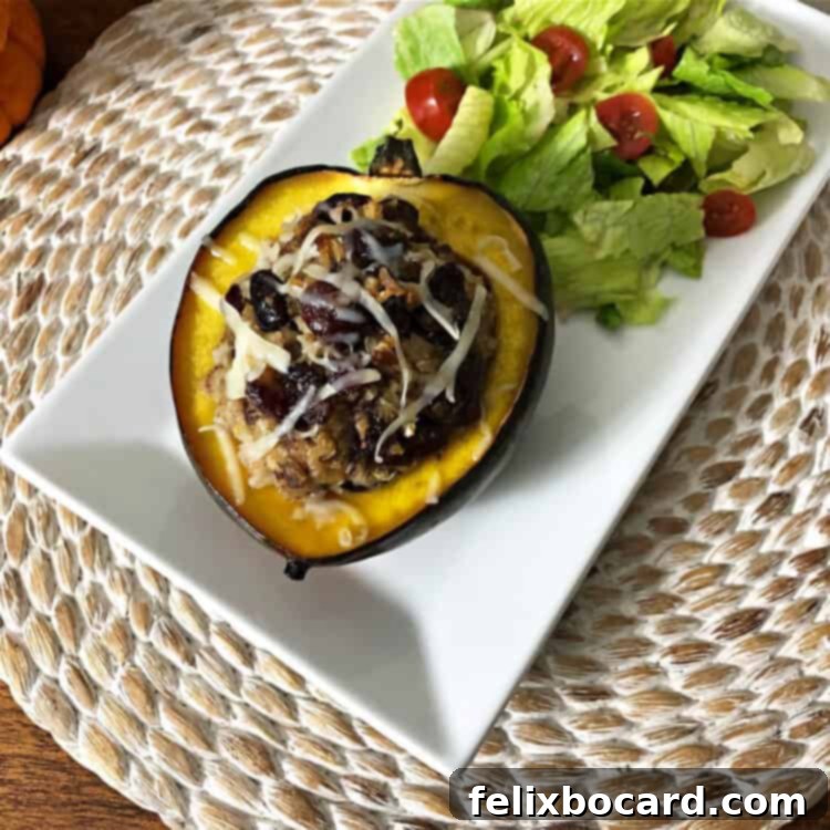 stuffed acorn squash on a white rectangular platter with a green salad