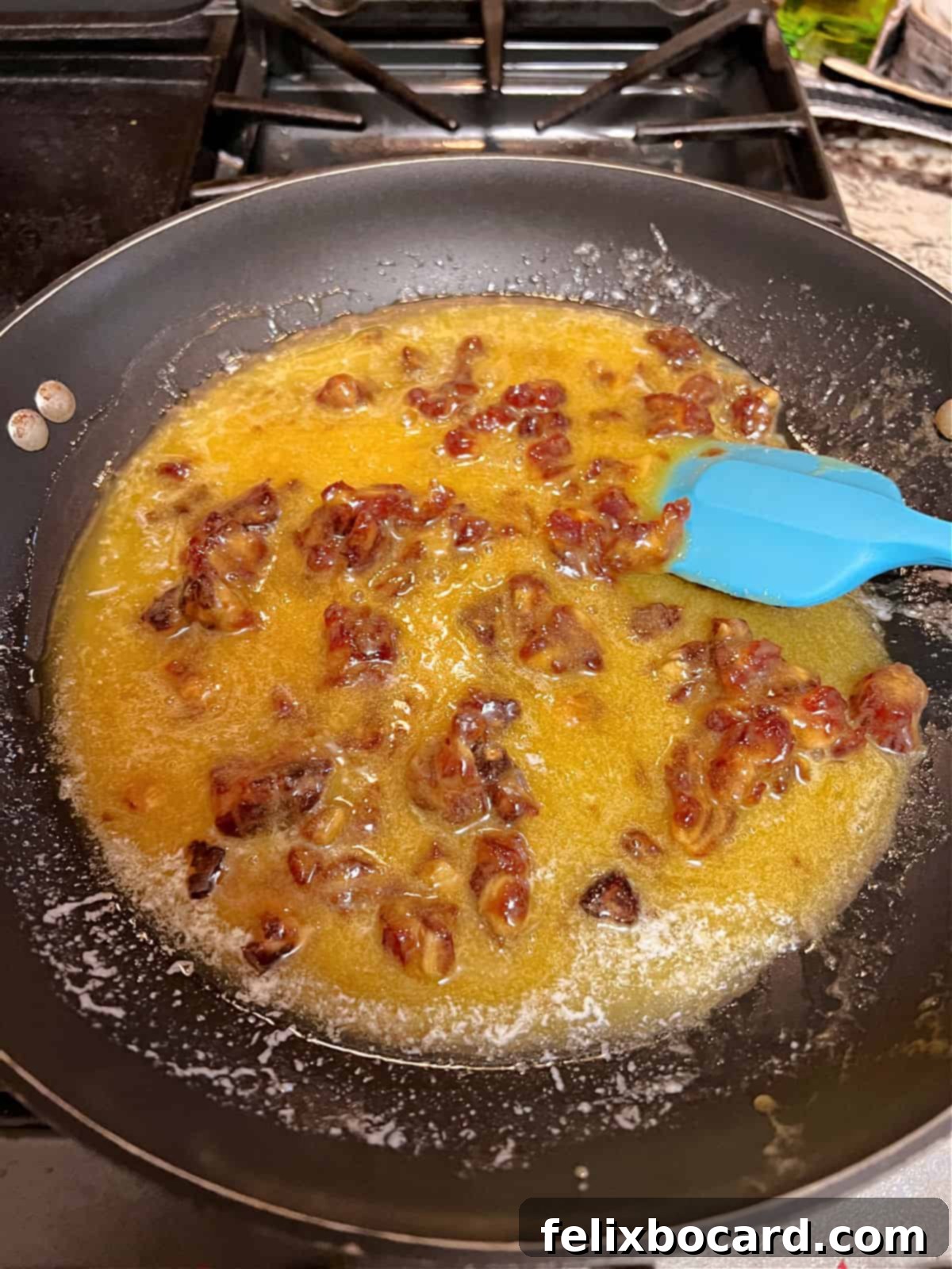 Coconut date cookie mixture cooking in a skillet.