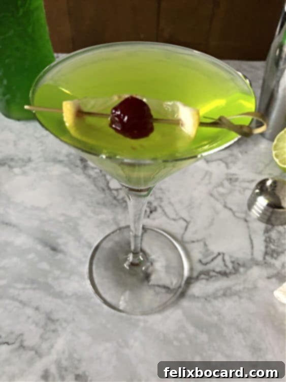 Vibrant Midori Sour 2 top down view of martini showing lemon and cherry garnish