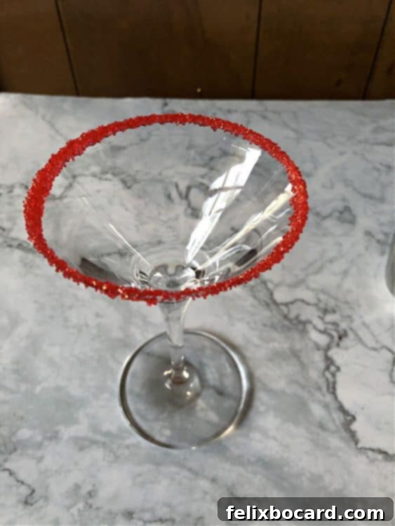 Martini glass rimmed with festive red sugar.
