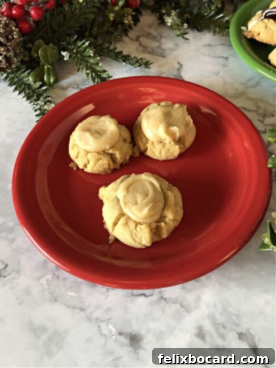 thumbprintcookies with icing on a red plate