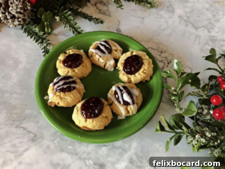 jam filled thumbprint cookies on a green plate
