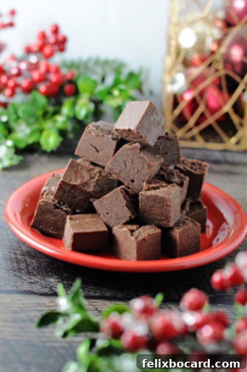 red plate piled with squares of nutella fudge, surrounded by holiday decor
