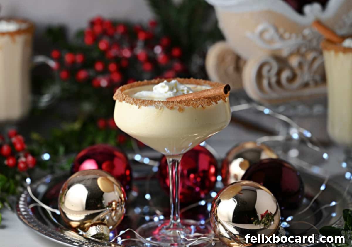 A festive Eggnog Baileys cocktail, beautifully presented in a coupe glass with a sugared rim, ready for holiday celebrations.