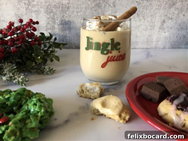 An Eggnog Baileys cocktail served on the rocks in a festive glass labeled 'Jingle Juice', perfect for a casual holiday drink.