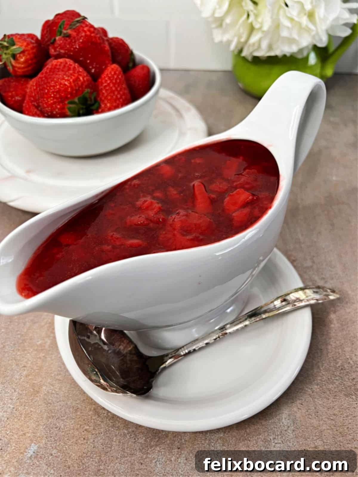 Simple Frozen Berry Sauce 2 A beautiful gravy boat filled with vibrant, homemade berry sauce made from frozen berries, ready to be served.