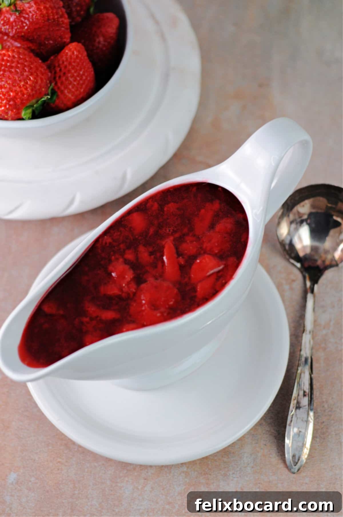 Simple Frozen Berry Sauce 6 A beautiful pourable serving dish holding luscious berry sauce, ready to be drizzled over various dishes.