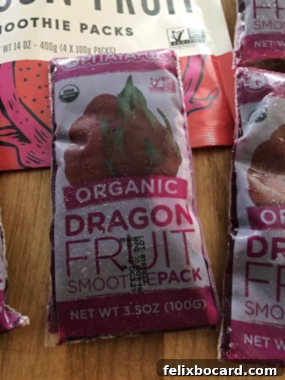 Close-up of a pitaya frozen puree pack, showing the bright pink color and product information.