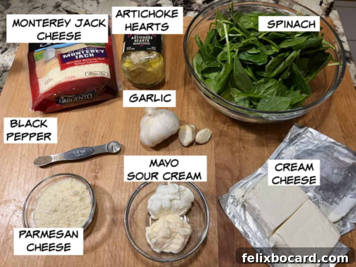 Arrangement of fresh ingredients for keto spinach artichoke dip, including Monterey Jack cheese, artichoke hearts, spinach, cream cheese, mayonnaise, sour cream, Parmesan cheese, garlic, and black pepper on a rustic surface.