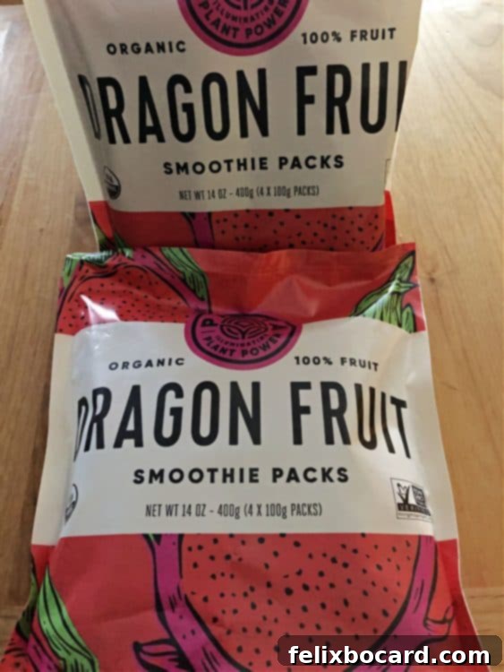 Selection of frozen dragon fruit puree packs available for purchase in a grocery store freezer aisle.