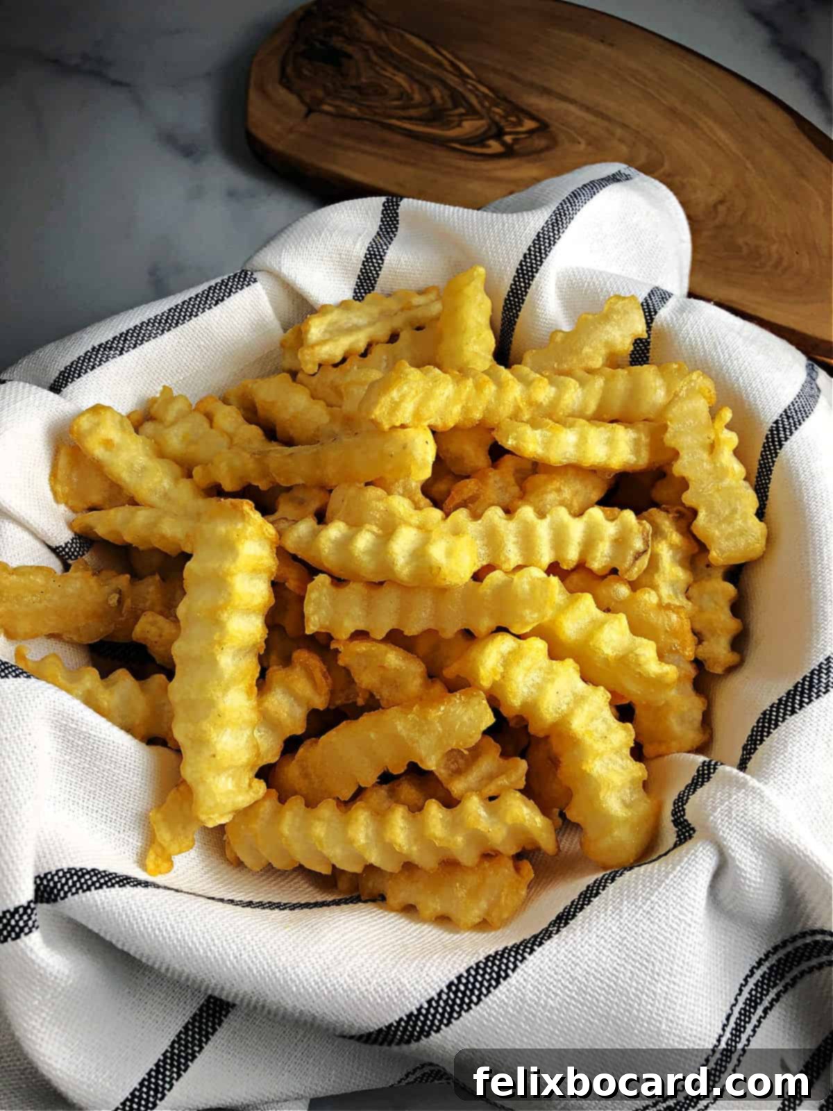 Crispy Air Fryer Frozen French Fries 5 cloth lined basket of french fries cooked with instant pot air fryer