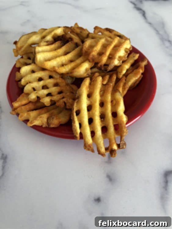 Crispy air fried waffle fries served on a small plate