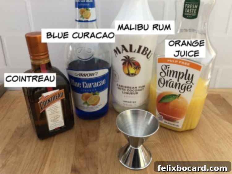 The four essential ingredients for a Shamrock Martini: Blue Curacao, Cointreau, Malibu Rum, and fresh orange juice.